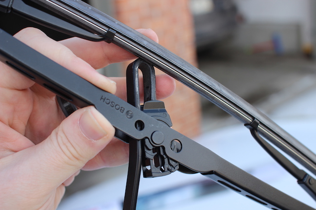 A hand holding a black blade.