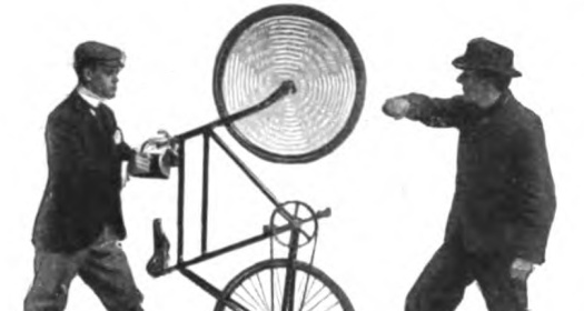 Two men standing next to a bicycle.