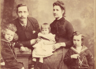 An old photo of a family posing for a picture in 1886.