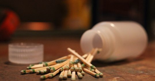 A jar of waterproof matches on a table.