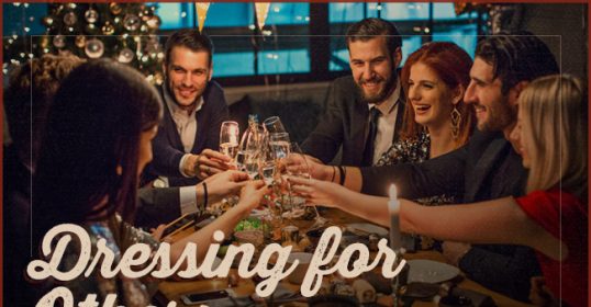 A group of people toasting at a table for others.