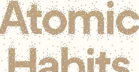 The word atomic habits in gold dots on a white background.