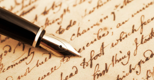 A fountain pen rests gracefully on a piece of paper.