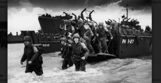 A black and white photo of soldiers on a boat, remembering D-Day.