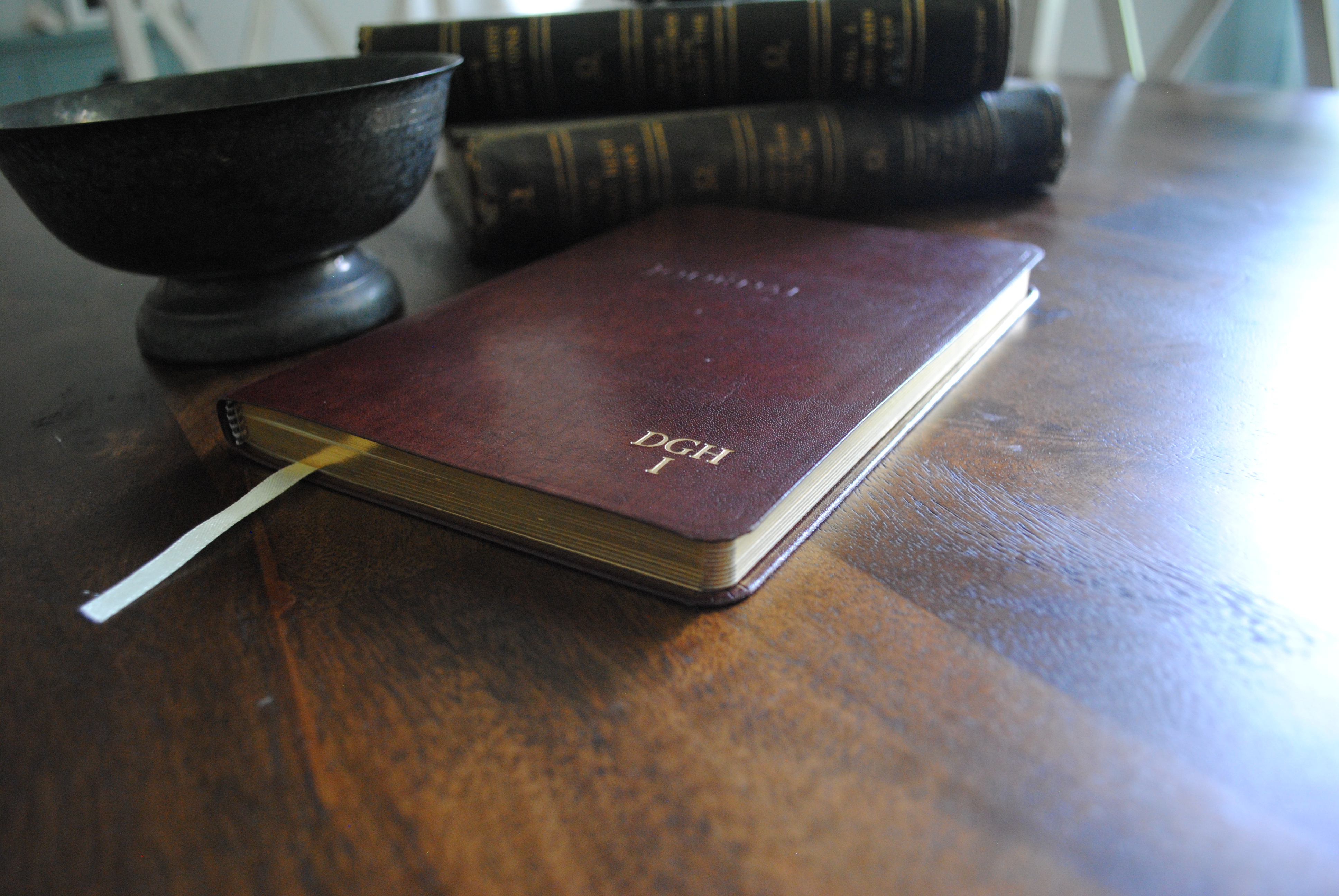 A man book is placed on a table next to a reservoir.