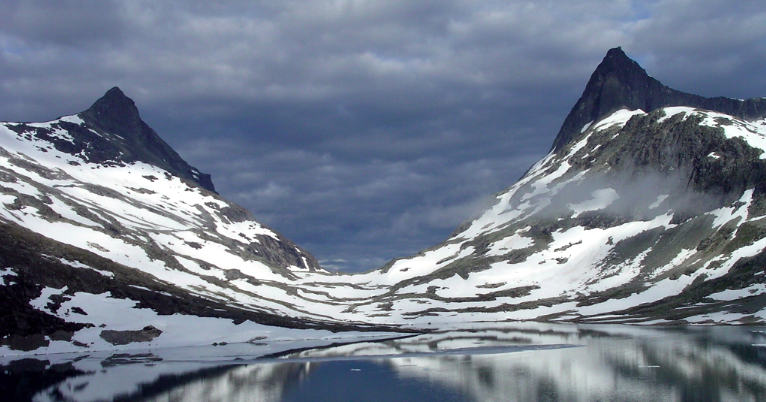 A lake nestled between snow-covered mountains, offering a serene escape.