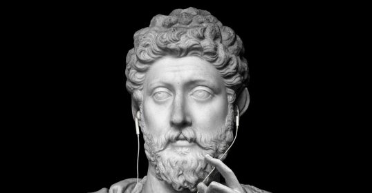 A bust of a man wearing headphones, resembling a Roman Emperor.