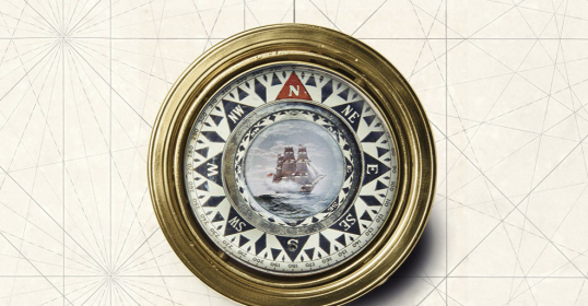 A gold frame with a picture of a ship, evoking thoughts of adventure and journey.