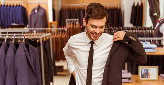 A man in a suit browsing a store to perfect his Men's Style.