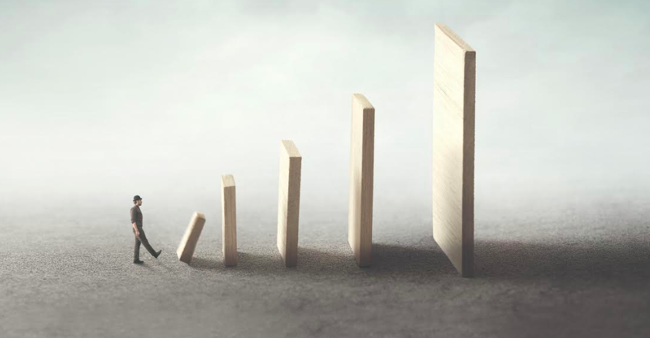 A man walking next to a wooden board with an arrow, symbolizing change.