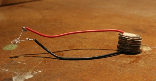 A red wire is sitting on a table.
