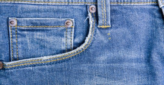 The jeans pocket is stitched onto the pants.