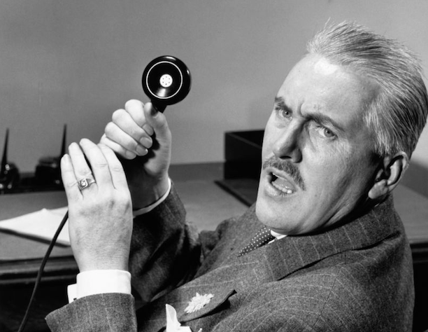 A man in a suit is holding a telephone to deal with jerks.