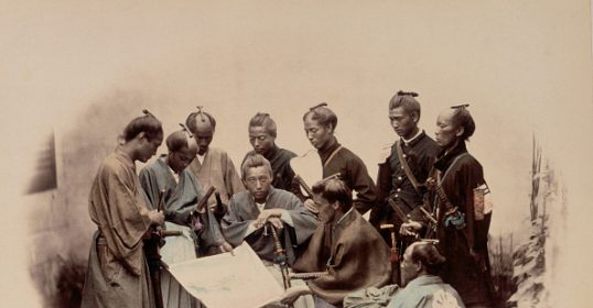 A group of warriors standing around a map.