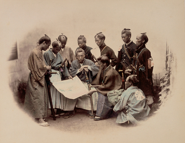 A group of warriors standing around a map.