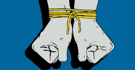 A pair of hands tied up with yellow string.