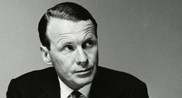 A black and white photo of an ad man in a suit.