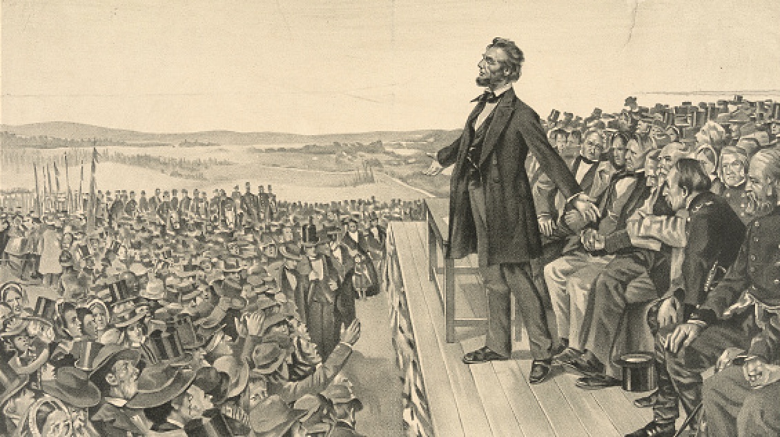 A man standing on a podium, showcasing his skills in public speaking to a captivated crowd.