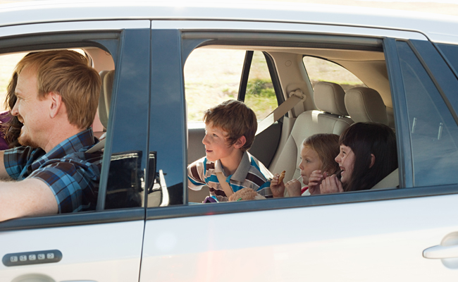 A family with kids in a car.
