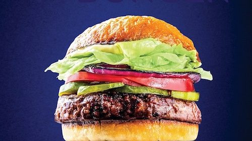 A perfect burger with lettuce and tomatoes on a blue background.