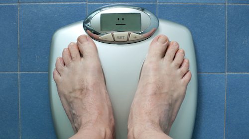 A person's weight on a scale.