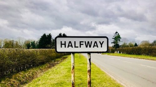 A road sign with the word halfway indicating a midlife shift.