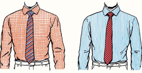 Two mannequins wearing matching shirts and ties.