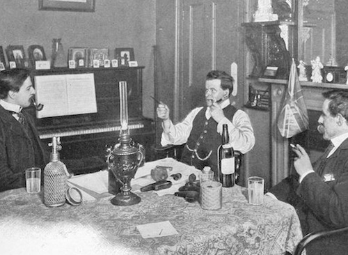 Three men sitting at a table with a bottle of wine, possibly celebrating an ideal bachelor party in 1906.