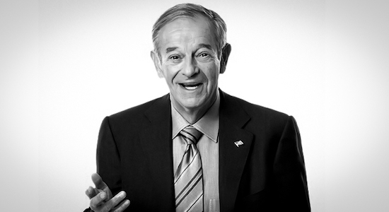A black and white photo of a man in a suit, portraying the essence of a negotiator.