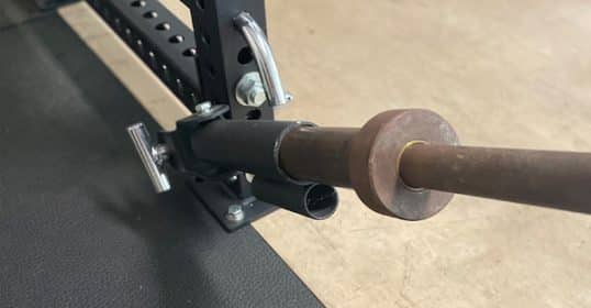 A squat rack with a bar suitable for strength training exercises.