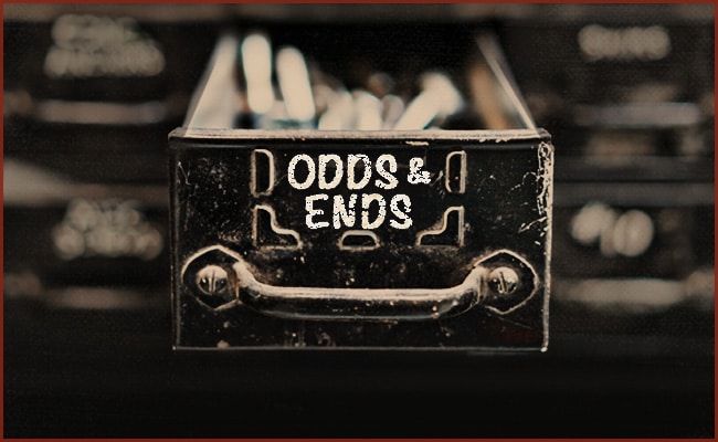 Close-up of a metal drawer with the label "ODDS & ENDS" partially pulled open, revealing various indistinct items inside. The background shows blurred labels on similar drawers.