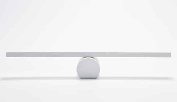 A simple balance scale with a single fulcrum on a plain background, symbolizing the concept of a dopamine reset.