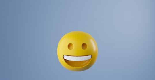 A smiley face emoji floating against a plain blue background, symbolizing the 