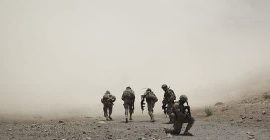 Soldiers walking through a dusty terrain, discussed in Podcast #916, 