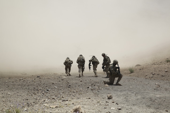 Soldiers walking through a dusty terrain, discussed in Podcast #916, "Why We Fight".
