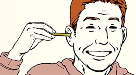 Man inserting a stick pencil into his ear.