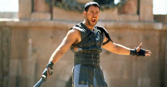 A man in a roman costume, exuding thumos, holding a sword.