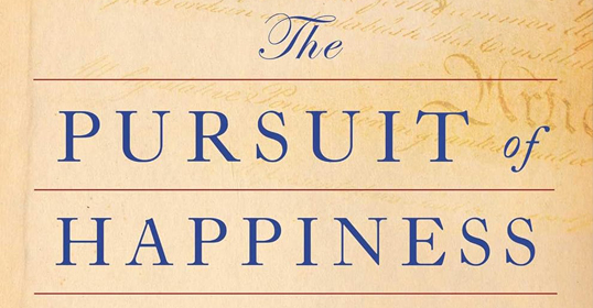 Text reading "The Pursuit of Happiness" in blue capital letters on a light brown, textured background. Fancy cursive text "The" and "of" contrast with bold serif letters for "PURSUT" and "HAPPINESS." Perfect for anyone on a self-improvement journey exploring the routines that lead to fulfillment.