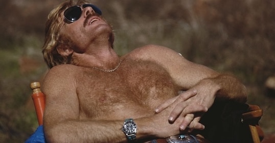 a man with a mustache wearing sunglasses