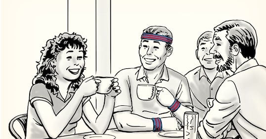 Four people sit around a table, smiling and socializing over mugs. One person wears a headband and wristbands. A can is visible on the table, giving the scene a relaxed, stress-free vibe.