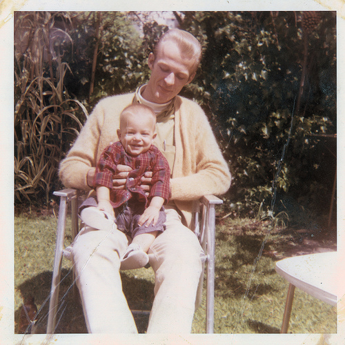 vintage father and infant son sitting 1950s 1960s