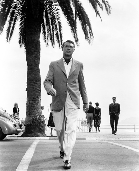 Cary Grant walking down at beach portrait.