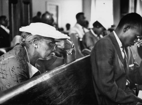 Vintage woman praying in the church.