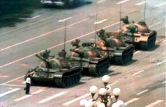 Man standing in front of tanks line.