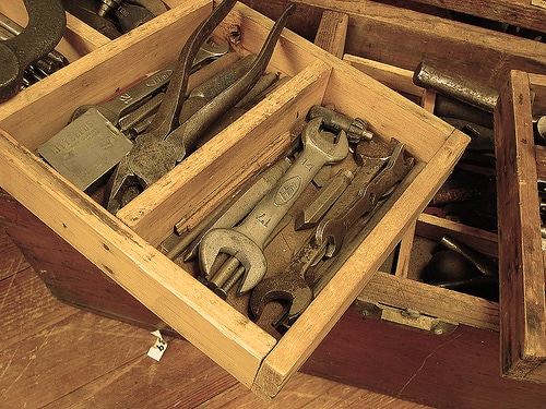Toolbox with wrenches and pliers.