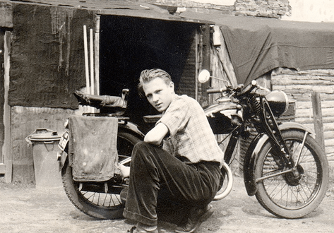 Vintage man giving pose with motorcycle. 