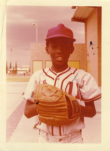 Child wearing a baseball glove.