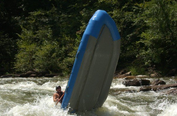 The rafting boat is lifted up due to back loading.