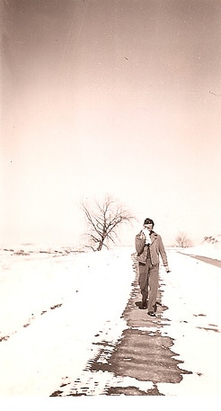 Vintage man walking on snowy path. 