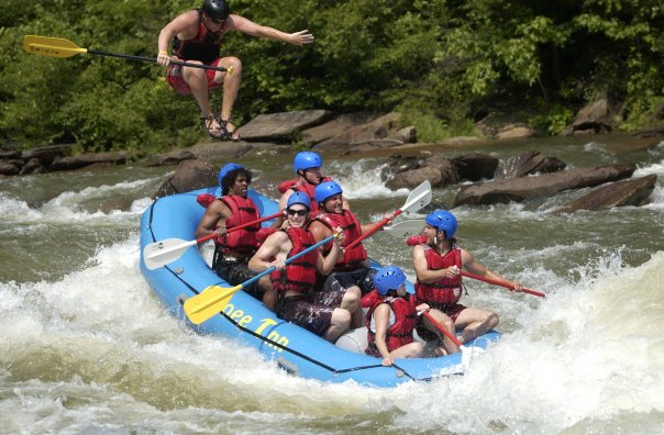 Joe Cope is jumping over the rafting boat.